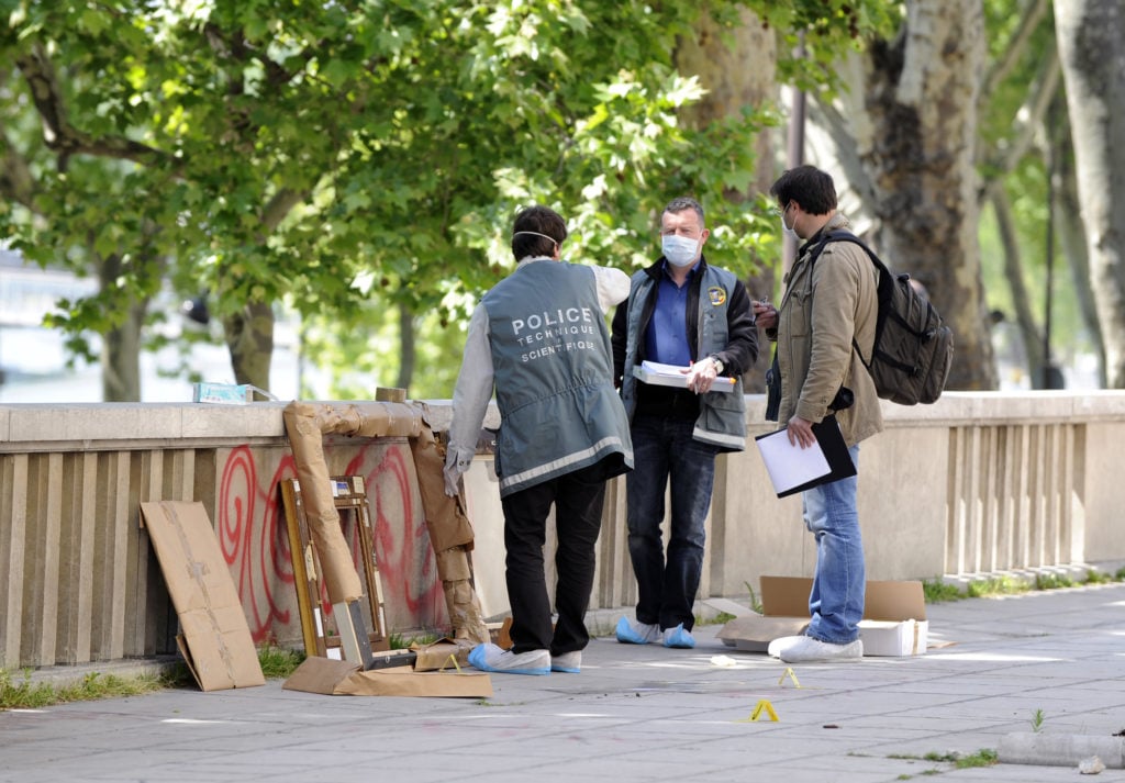 Policemen stand by painting frames outside the Paris' Musee d'Art Moderne (Paris modern art museum) where five works including paintings by modern masters Henri Matisse and Pablo Picasso were stolen on May 20, 2010. Photo courtesy BERTRAND GUAY/AFP/Getty Images.