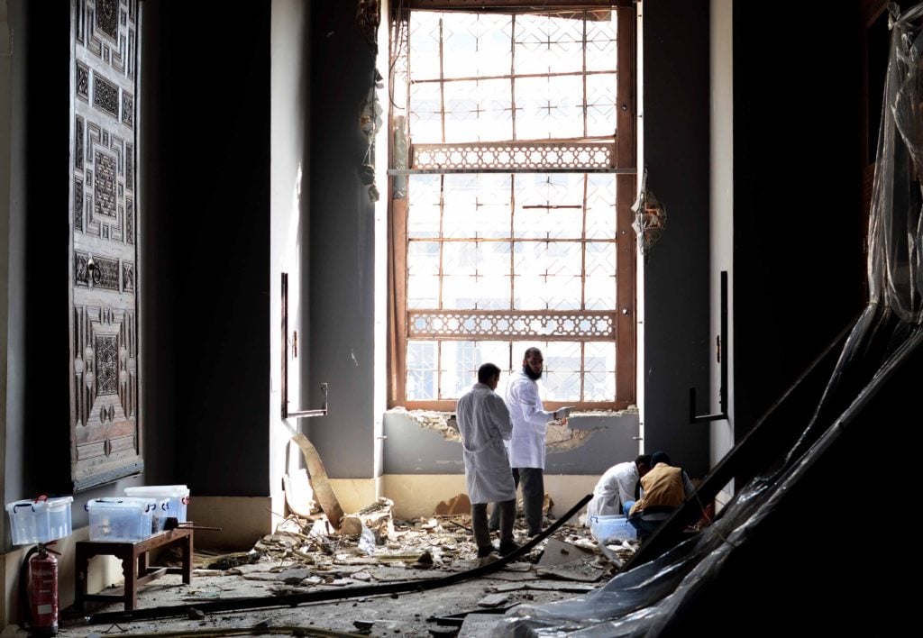 Workers inspect the damage in the Museum of Islamic Art in Cairo on January 26, 2014 after it was hit during a car bomb explosion outside the police headquarters near the museum on January 24 in the Egyptian capital. Photo Courtesy MOHAMED EL-SHAHED/AFP/Getty Images.