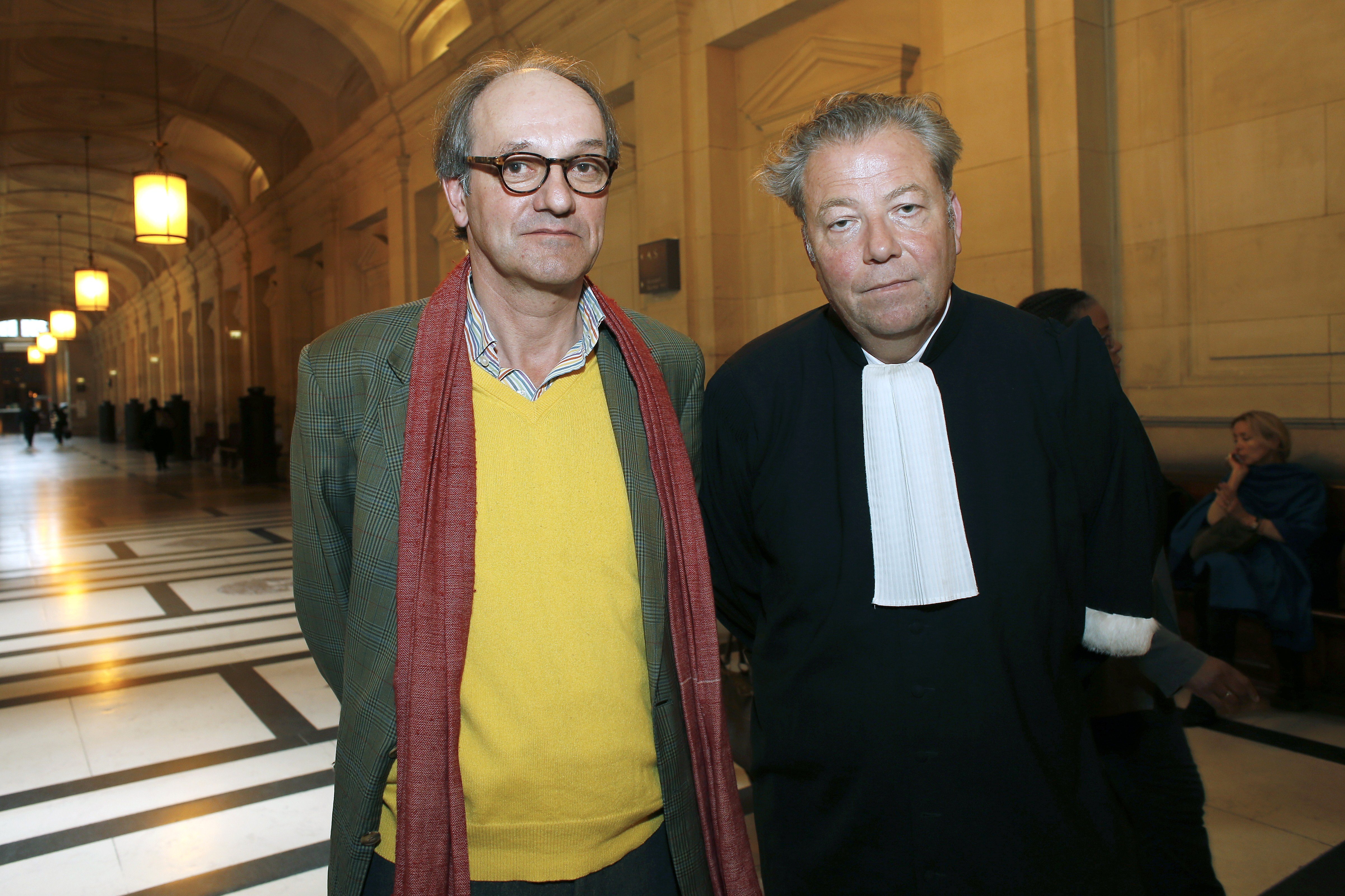 Peggy Guggenheim's grandson Sandro Rumney (L) poses with his lawyer Olivier Morice during the appealing trial in Paris, on May 19, 2015. The descendants of famous heiress and art collector Peggy Guggenheim launched a court appeal over her collection of works housed in a palace on Venice's Grand Canal. In 1979, Peggy Guggenheim handed over the palace and its collection to the Solomon Guggenheim Foundation based in New York. The plaintiffs complain that works from other collections are now being displayed at the Palazzo, diluting Peggy's work. They call for the collection to be restored to its original configuration. Courtesy Thomas Samson/AFP/Getty Images.