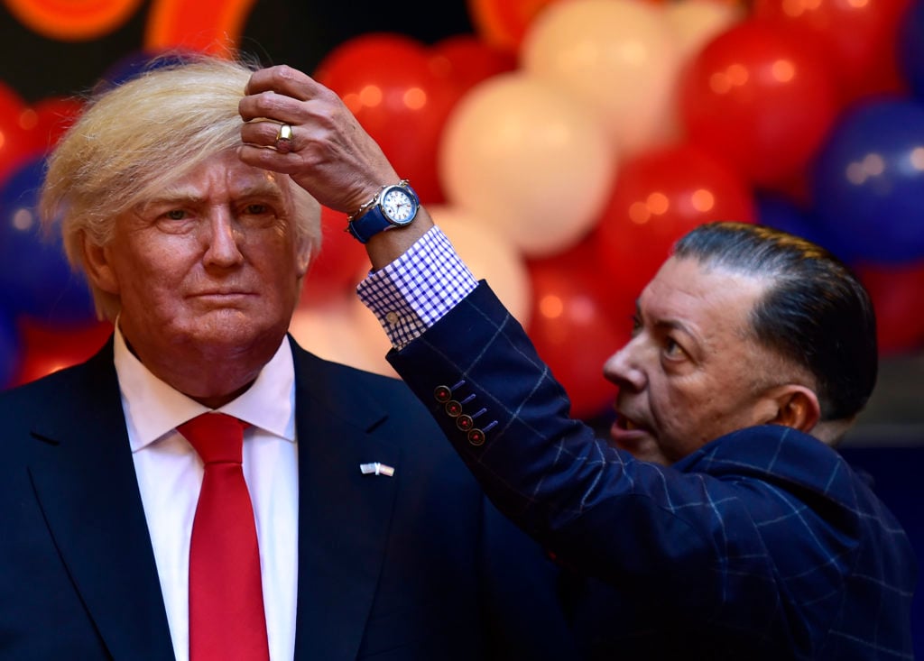Madrid's Wax Museum director Gonzalo Presa checks the hair of the wax statue of US President-elect Donald Trump during its presentation at the Wax Museum of Madrid. Courtesy of Gerard Julien/AFP/Getty Images.