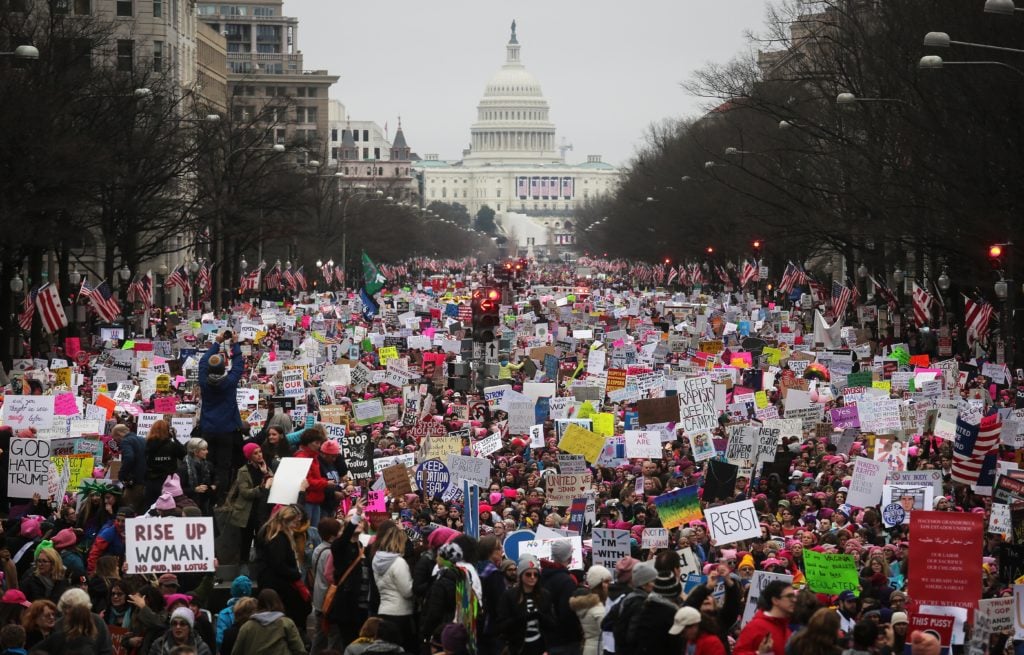 Protesters walk up Pennsylvania Avenue during the Women's March on Washington, with the US Capitol in the background, on January 21, 2017 in Washington, DC. Large crowds are attending the anti-Trump rally a day after US President Donald Trump was sworn in as the 45th US president. Courtesy of Mario Tama/Getty Images.