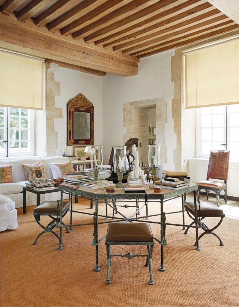 Installation view of Hubert de Givenchy's Chateau du Jonchet with Diego Giacometti table. 