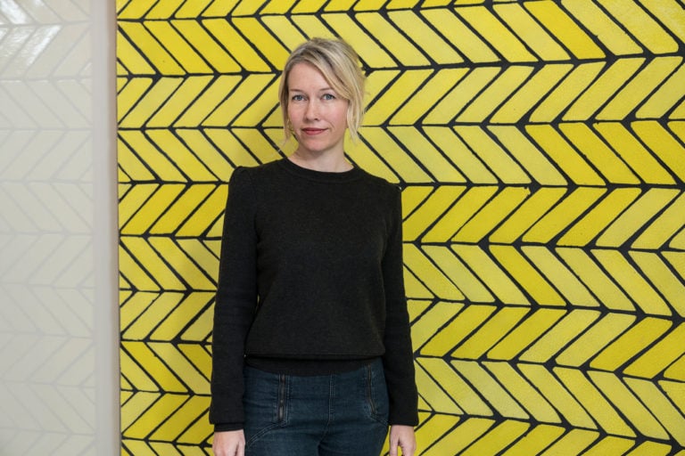 Sarah Crowner in front of Wall (Yellow Teracotta) at the Wright Restaurant at the Guggenheim Museum. Courtesy of David Heald / Solomon R. Guggenheim Foundation.