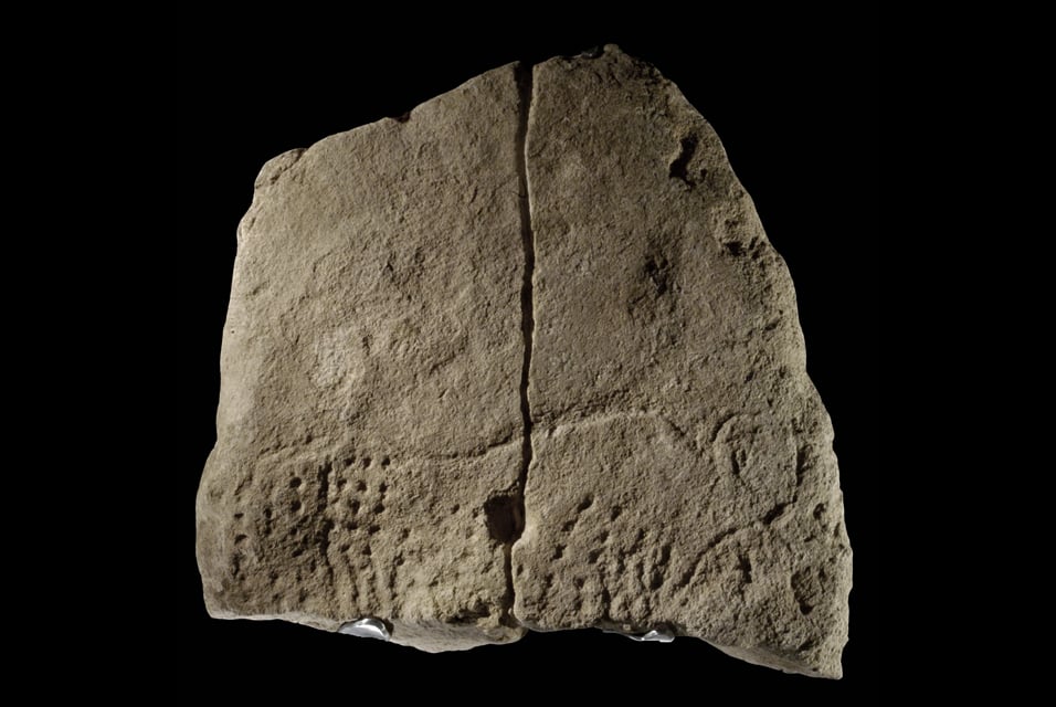 Limestone slab engraved with image of an aurochs, or extinct wild cow, discovered at Abri Blanchard in 2012. Courtesy of Musée national de Préhistoire collections/photographer MNP - Ph. Jugie.