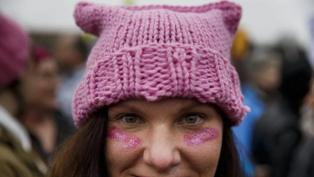 A demonstrator stands for a photograph while wearing a pink hat during the Women's March on Washington in Washington, DC, on Saturday, January 21, 2017. Photo by Patrick T. Fallon/Bloomberg via Getty Images.