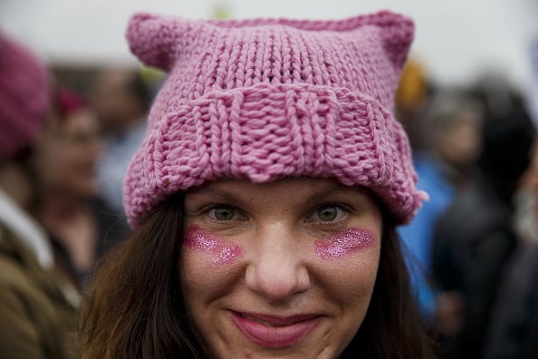 A demonstrator stands for a photograph while wearing a pink hat during the Women's March on Washington in Washington, D.C., U.S., on Saturday, Jan. 21, 2017. Photo by Patrick T. Fallon/Bloomberg via Getty Images.