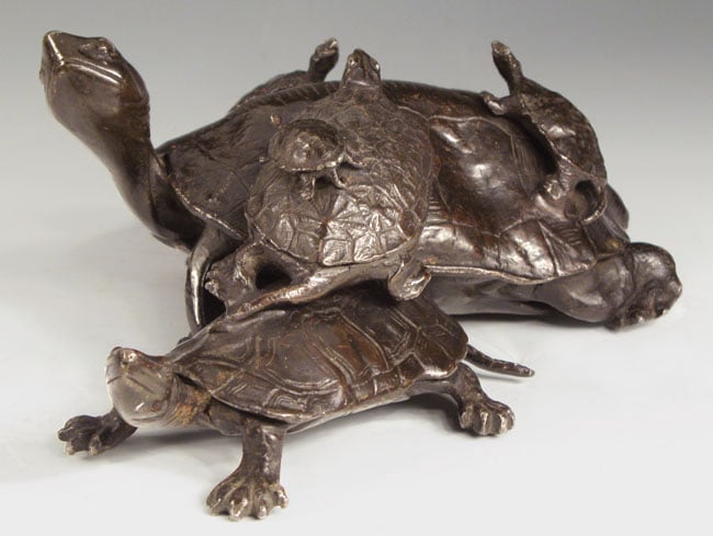 A bronze okimono of a realistically chiseled terrapin family, the offspring clambering upon the parent’s back and the precise physical details of their skins and carapace expertly rendered. Meiji Period, Japan. Courtesy of Flying Cranes Antiques.