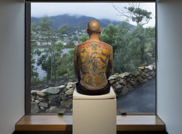 Tim Steiner exhibiting his Wim Delvoye tattoo in Hobart, Tasmania, at the Museum of Old and New Art in 2012. Courtesy of Wim Delvoye.