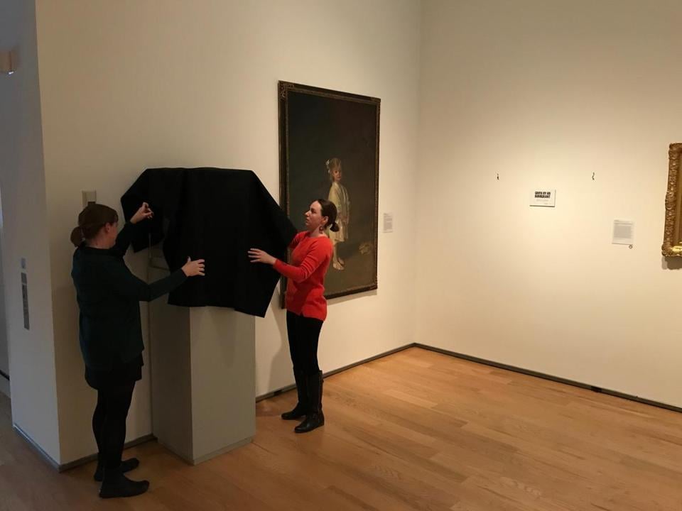 The staff at the Davis Museum at Wellesley College de-installs a work for "Art-Less." Courtesy of the Davis Museum at Wellesley College. 