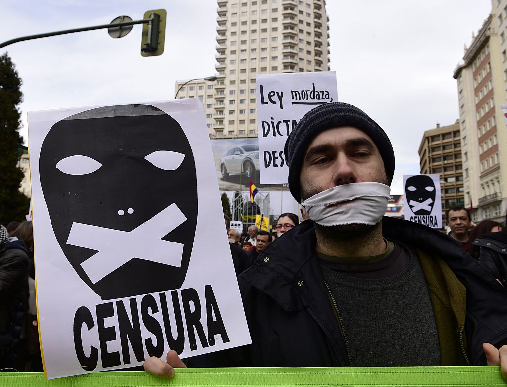 A demonstrator holds a placard reading "Censorship." Photo: Javier Soriano/AFP/Getty Images.