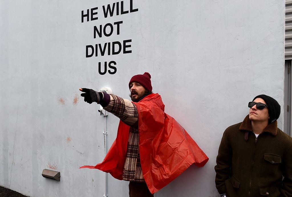 Shia LaBeouf (L) during a "He Will Not Divide Us" livestream outside the Museum of the Moving Image in New York January 24, 2017. Photo courtesy TIMOTHY A. CLARY/AFP/Getty Images.