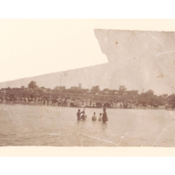 River baptism witnessed by hundreds as an African American minister performs the ceremony. People, horses, and buildings visible on the riverbank (circa late-19th century). Courtesy of the Loewentheil Collection of African-American Photographs, Cornell University Library.
