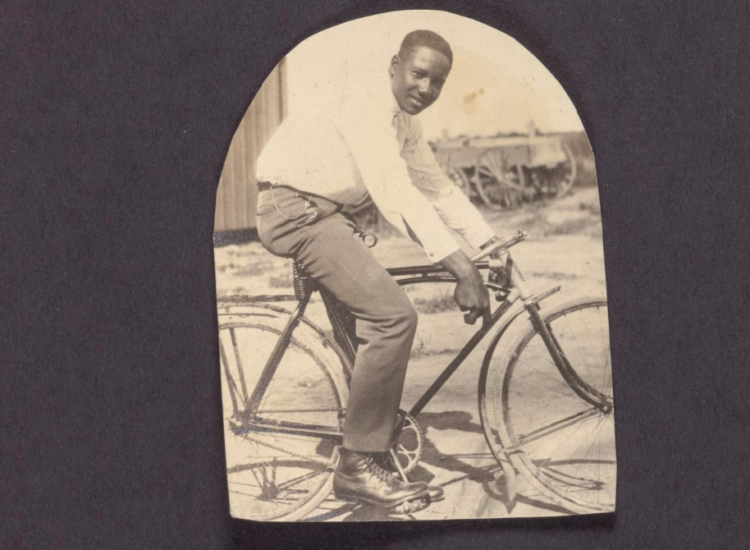 Picture of a man on sitting on a bicycle (circa 1920s). Courtesy of the Loewentheil Collection of African-American Photographs, Cornell University Library.