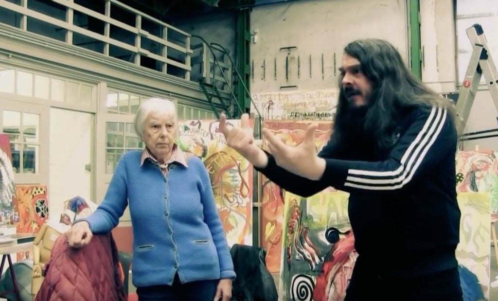 Jonathan Meese in his studio with his mother. Photo: video still via YouTube.