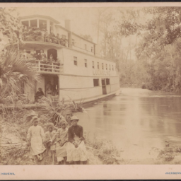 O. Pierre Havens, Lucas Line steamship, with African American children on the riverbank in foreground. Well-dressed white people sit high up on the ship (Circa late-19th century).Courtesy of the Loewentheil Collection of African-American Photographs, Cornell University Library.