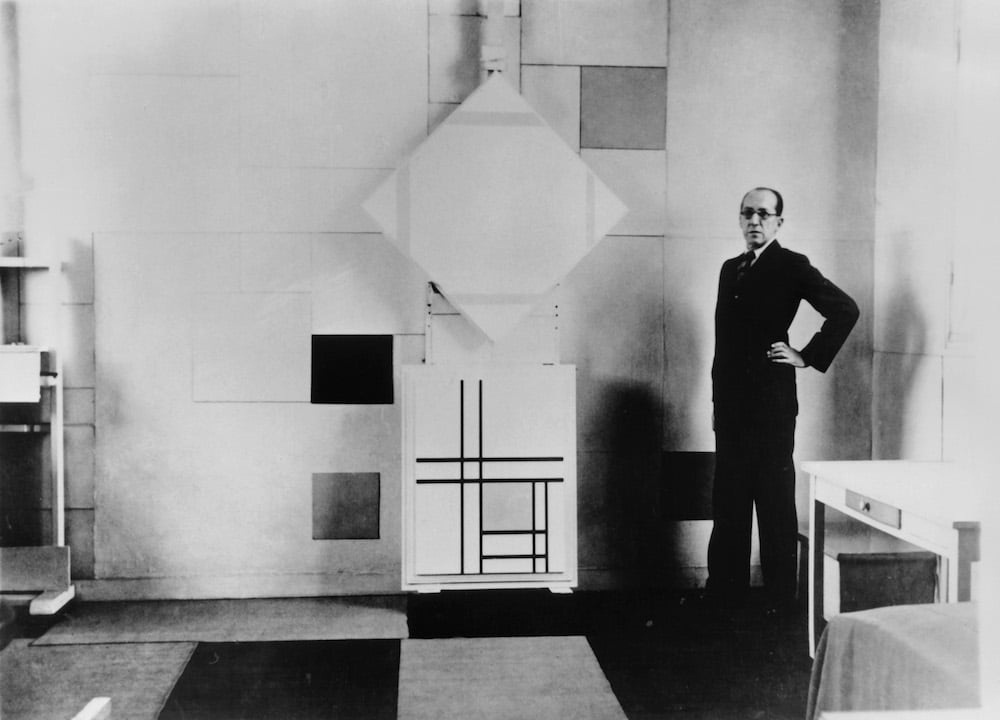 Piet Mondrian in his studio with (top) Lozenge Composition with Four Yellow Lines (1933) and (bottom) Composition with Double Lines and Yellow, (1934). Paris, October 1933. Collection RKD – Netherlands Institute for Art History. Photo credit Charles Karsten.