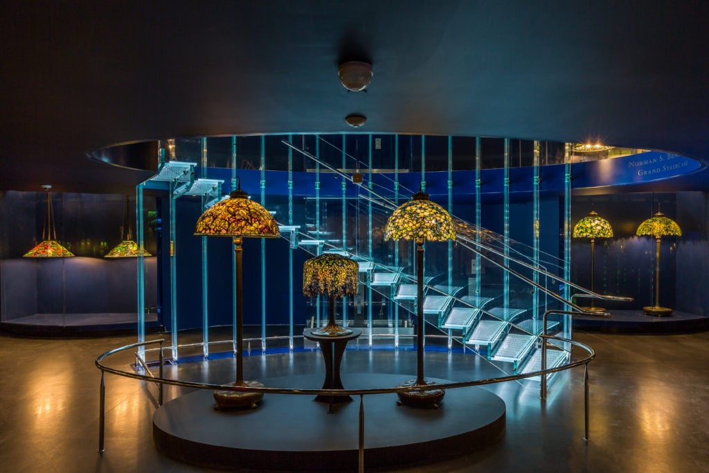 The Gallery of Tiffany Lamps, designed by Czech architect Eva Jiřičná, comprises a 4,800-square-foot, two-story space measuring nearly a city block with its soaring glass Norman S. Benzaquen Grand Staircase.   Courtesy of the New-York Historical Society/Corrado Serra.