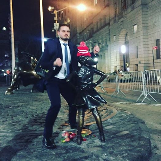 Kristen Visbal's <em>The Fearless Girl</em> statue is assaulted by a Wall Street bro. Photo by Alexis Kaloyanides. 