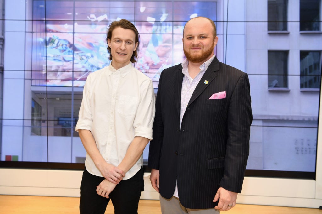 Digital artist Tabor Robak and Microsoft creative director Florin Gale attend the unveiling of Robak's original art installation at the Flagship Microsoft Store. Courtesy of Dave Kotinsky/Getty Images for Microsoft.