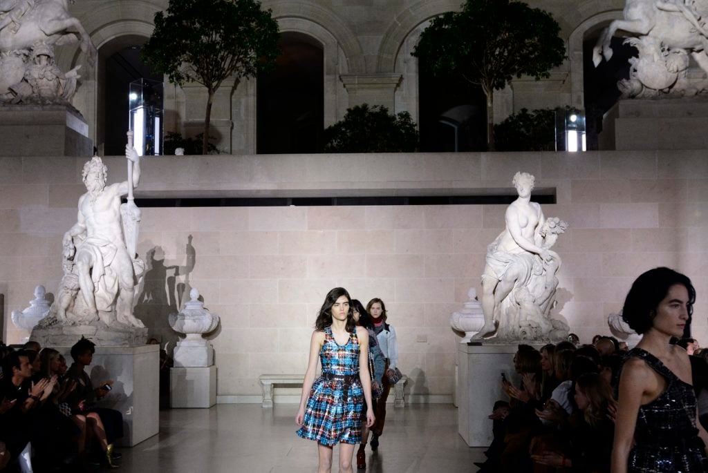 Models walk the catwalk at The Louvre. Photo BERTRAND GUAY/AFP/Getty Images