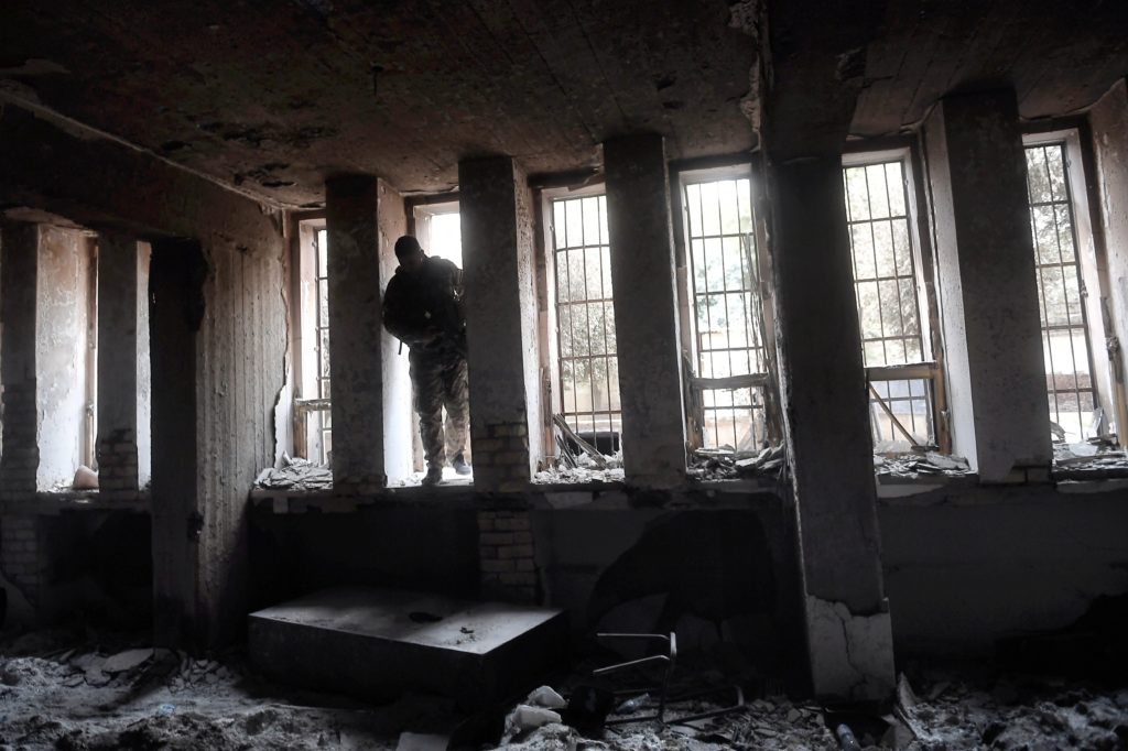 A member of the Iraqi forces enters the destroyed building of the museum of Mosul. Photo ARIS MESSINIS/AFP/Getty Images
