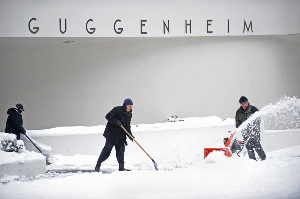 Workers clear snow in front of the Guggenheim Museum in 2010. Courtesy of Stan Honda/AFP/Getty Images.