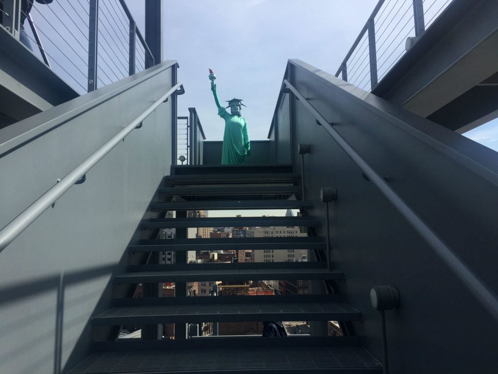 Performance by Puppies Puppies featuring a live performer costumed as the Statue of Liberty, on the roof terrace of the Whitney Biennial. Image: Ben Davis.