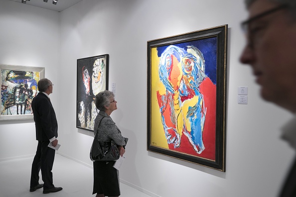 A visitor looks at the artwork "Boy" by Dutch artist Karel Appel during the press preview of The European Fine Art Fair (TEFAF) in Maastricht on March 9, 2017. Photo Marcel van Hoorn/AFP/Getty Images.