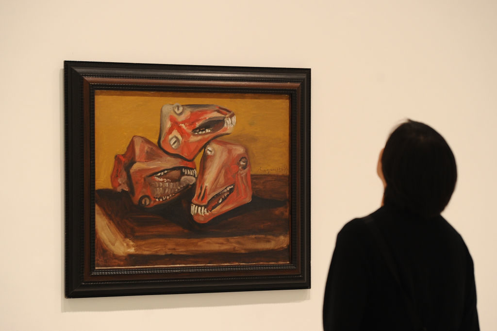 A museum visitor looks at a work by Pablo Picasso at the Museo Reina Sofia, in Madrid. Photo Denis Doyle/Getty Images.