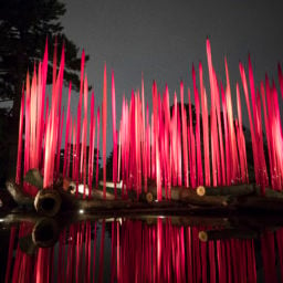Dale Chihuly, Red Reeds on Logs (2017). Courtesy the New York Botanical Garden, Photo By Ben Hider.