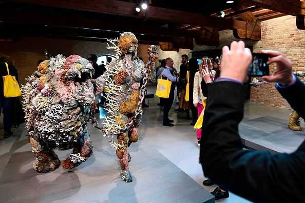 People look at ''Lion Woman of Asit Mayor'' by British artist Damien Hirst during the press presentation of his exhibition 'Treasures from the Wreck of the Unbelievable' at the Pinault Collection in Punta della Dogana and Palazzo Grassi in Venice on April 6, 2017. Photo credit should read Miguel MedinaAFPGetty Images.