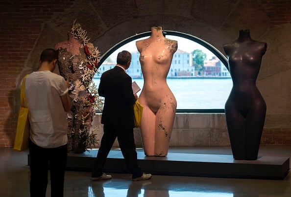 Visitors look at the three 'Grecian Nude' during the press presentation of the exhibition 'Treasures from the Wreck of the Unbelievable' by British artist Damien Hirst at the Pinault Collection in Punta della Dogana and Palazzo Grassi in Venice on April 6, 2017. Photo credit should read Miguel Medina/AFP/Getty Images.