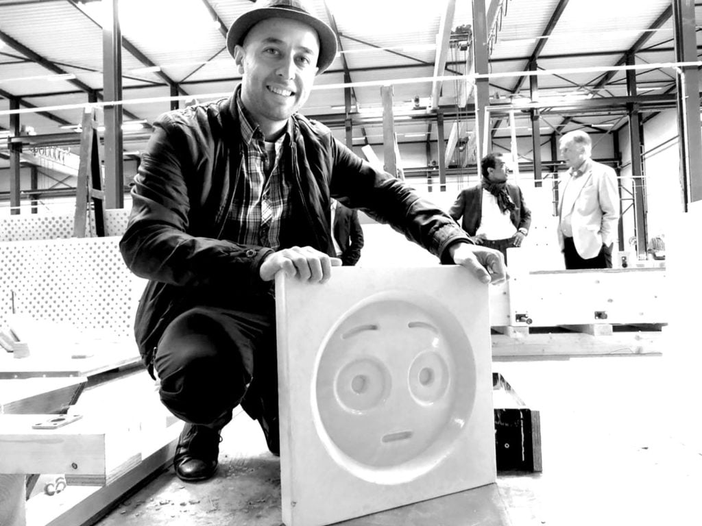 Changiz Tehrani of Attika Architekten with a concrete emoji mold. Courtesy Attika Architekten/photographer Bart van Hoek.