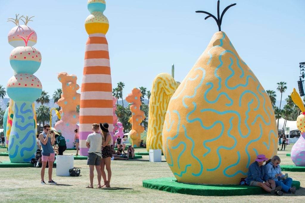Festival goers seeking shade under the bulbous blooms of CHIAOZZO. Photo courtesy of Valerie Macon/AFP/Getty Images.