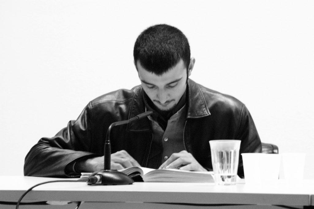Santiago Sierra, 120 hours of continuous reading of a telephone book, (2004). Helga de Alvear Gallery, Madrid. Photo courtesy Santiago Sierra Studio.Santiago Sierra, 120 hours of continuous reading of a telephone book, (2004). Helga de Alvear Gallery, Madrid. Photo courtesy Santiago Sierra Studio.