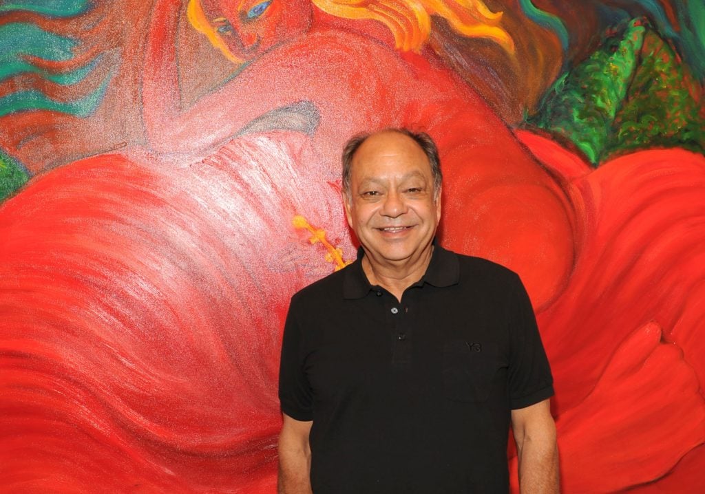 Cheech Marin with a painting by Margaret Garcia in 2012. ©Patrick McMullan.
