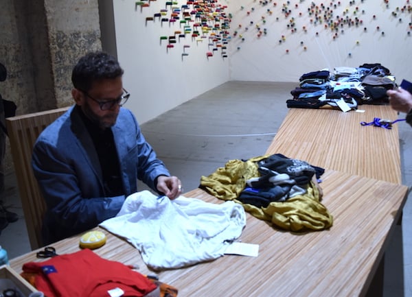 A tailor at work for Lee Mingwei's <i>The Mending Project</i> (2009-2017) loaned to the 2017 Venice Biennale by Rudy Tseng. Image: Ben Davis.