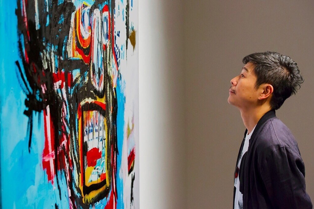 Yusaku Maezawa gazes adoringly at his new artwork. Image via Instagram.