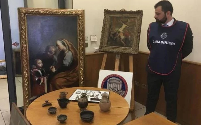 An Italian policeman with recovered stolen art. Courtesy of the Italian police.