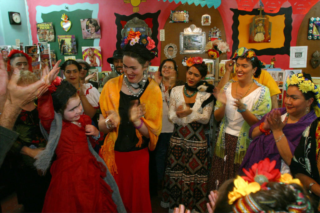 Ruby Alford (L) and her mother Mary Rafferty (2nd from L) acknowledge the crowd's applause as they win first place in the Frida Kahlo lookalike contest at the In Croud November 2, 2002 in Albuquerque, New Mexico. Courtesy of Phillippe Diederich/ Getty Images.