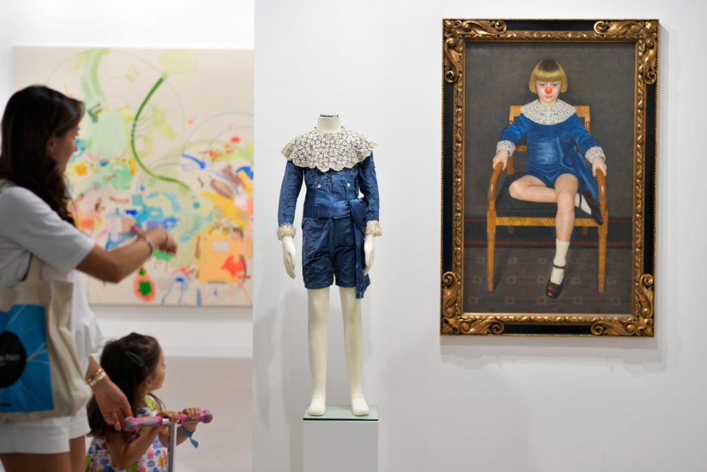 Art Basel visitors admire work by Hans-Peter Feldmann at 303 Gallery's booth. Courtesy FABRICE COFFRINI/AFP/Getty Images.