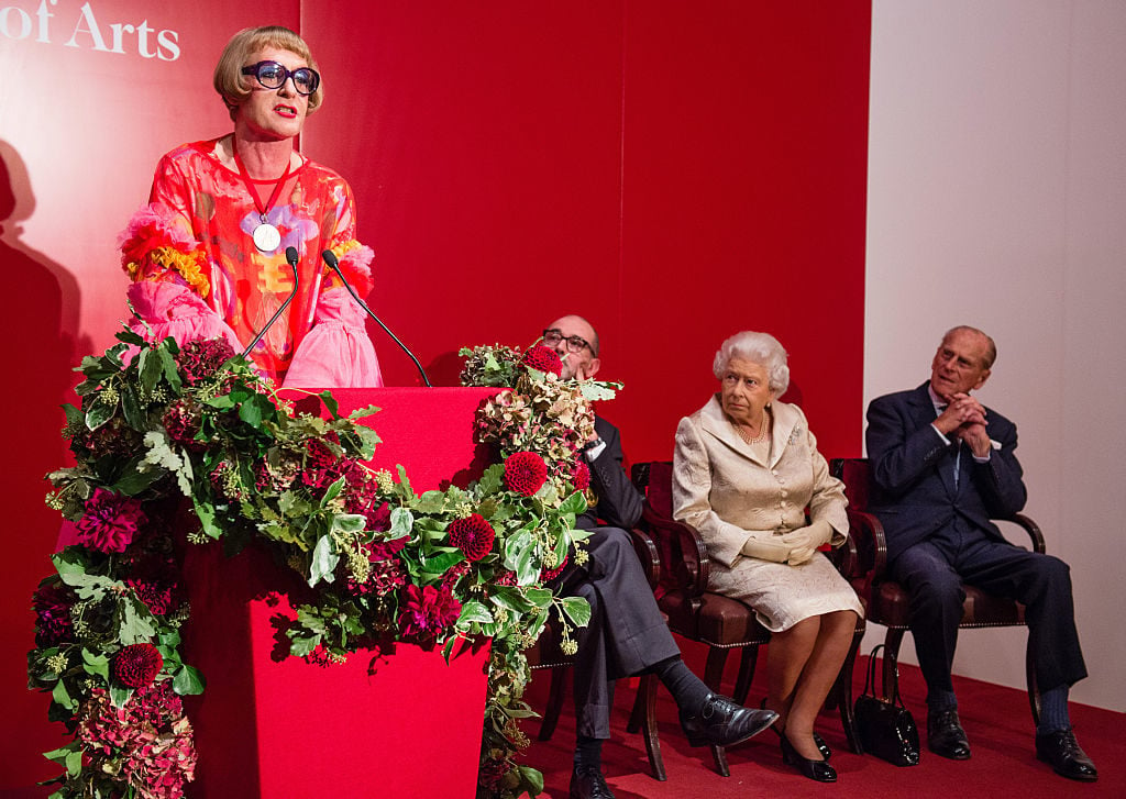 Grayson Perry speaks as Queen Elizabeth II and Prince Philip, Duke of Edinburgh look on as they attend a reception and awards ceremony at Royal Academy of Arts on October 11, 2016 in London, England. Photo Jeff Spicer/Getty Images.