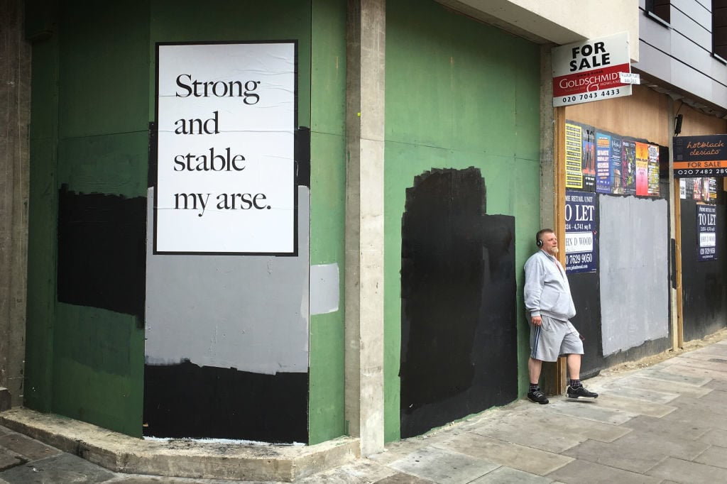 A poster by artist Jeremy Deller, in response to Prime Minister Theresa May, is pasted onto a wall in Camden, May 27, 2017 in London, England. Britain goes to the polls on June 8 to elect a new parliament in a general election. Photo Jim Dyson/Getty Images.
