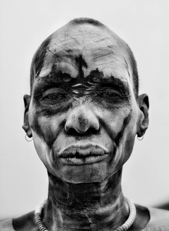 Sebastião Salgado's <em>Dinka man at the cattle camp of Kei. People cover themselves with ash from burned cowpats to sterilize the skin against insects and parasites, Southern Sudan</em>, 2006