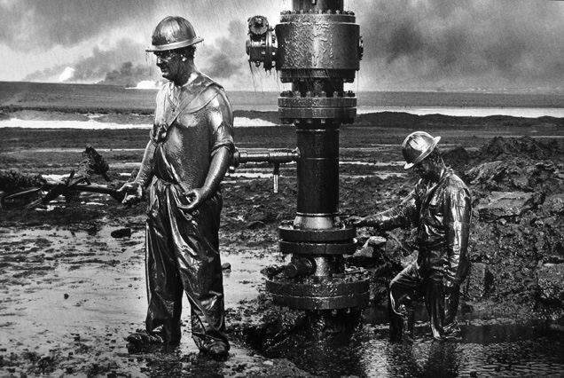 Sebastião Salgado's <em>Workers install a new wellhead to enable the injection of a chemical mud to kill the old well. Greater Burhan, Kuwait</em>, 1991