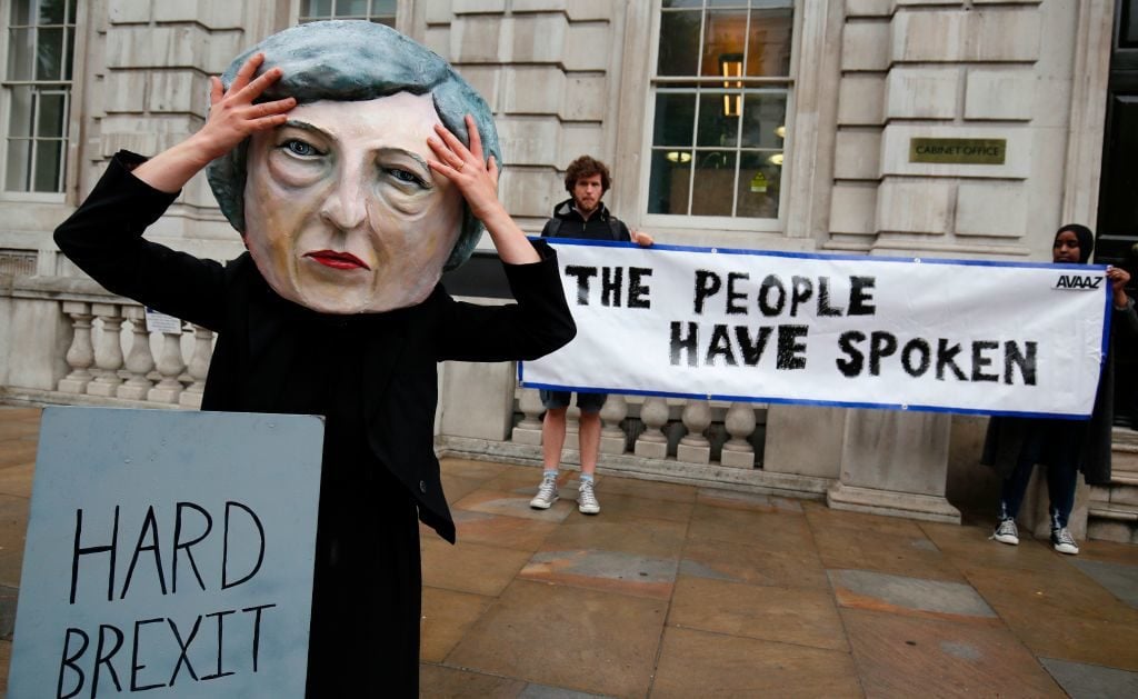A demonstrator wears a mask depicting Britain's Prime Minister and leader of the Conservative Party Theresa May during a protest photocall near the entrance 10 Downing Street in central London on June 9, 2017 as results from a snap general election show the Conservatives have lost their majority. Photo ADRIAN DENNIS/AFP/Getty Images.