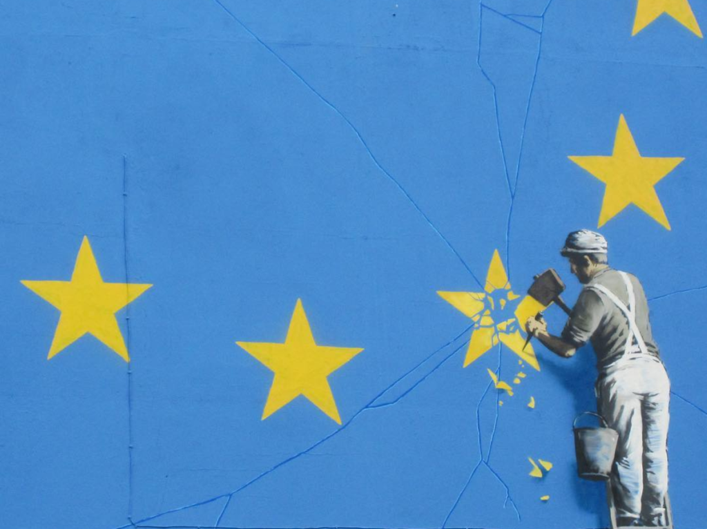 A recently painted mural by British graffiti artist Banksy, depicting a workman chipping away at one of the stars on a European Union (EU) themed flag, is pictured in Dover, south east England. Courtesy of Banksy, via Instagram.