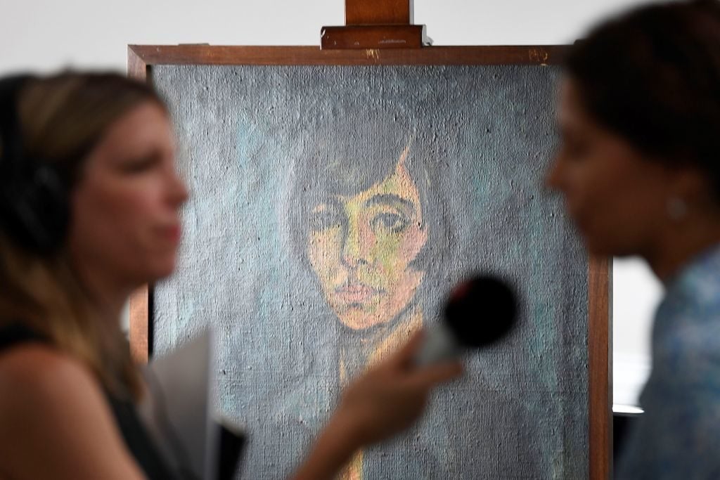 A woman is interviewed during the press preview of the first masterpieces of the estate of German collector Cornelius Gurlitt at the Museum of Fine Arts Bern (Kunstmuseum Bern). Photo: Valeriano di Domenico/AFP/Getty Images.