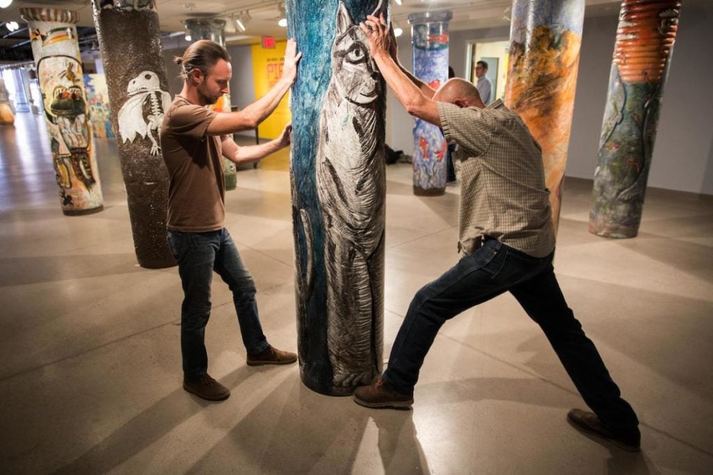 Exhibit specialists Chris Miller and Stephen Johnson installing "Pipe Brothers: Tom and James Franco," at the ASU Art Museum Ceramics Research Center. Courtesy of Deanna Dent/ASU Now.