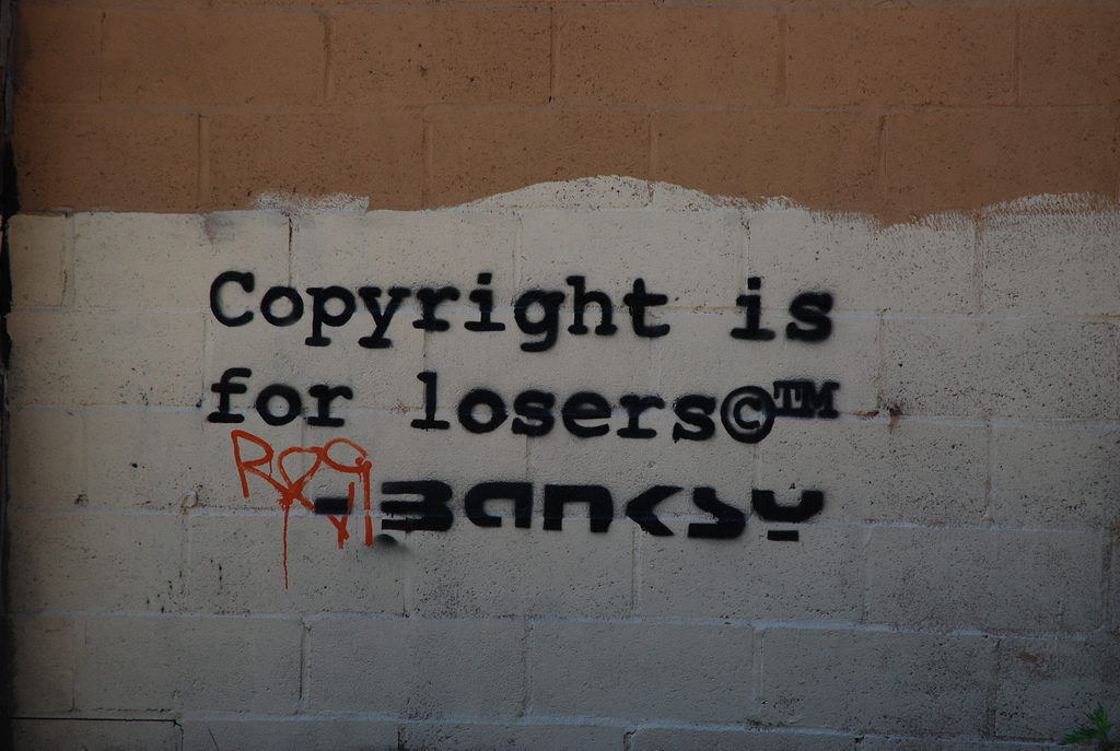 A fake Banksy graffiti tag. Photo licensed via CC, courtesy dumbonyc via Flickr.
